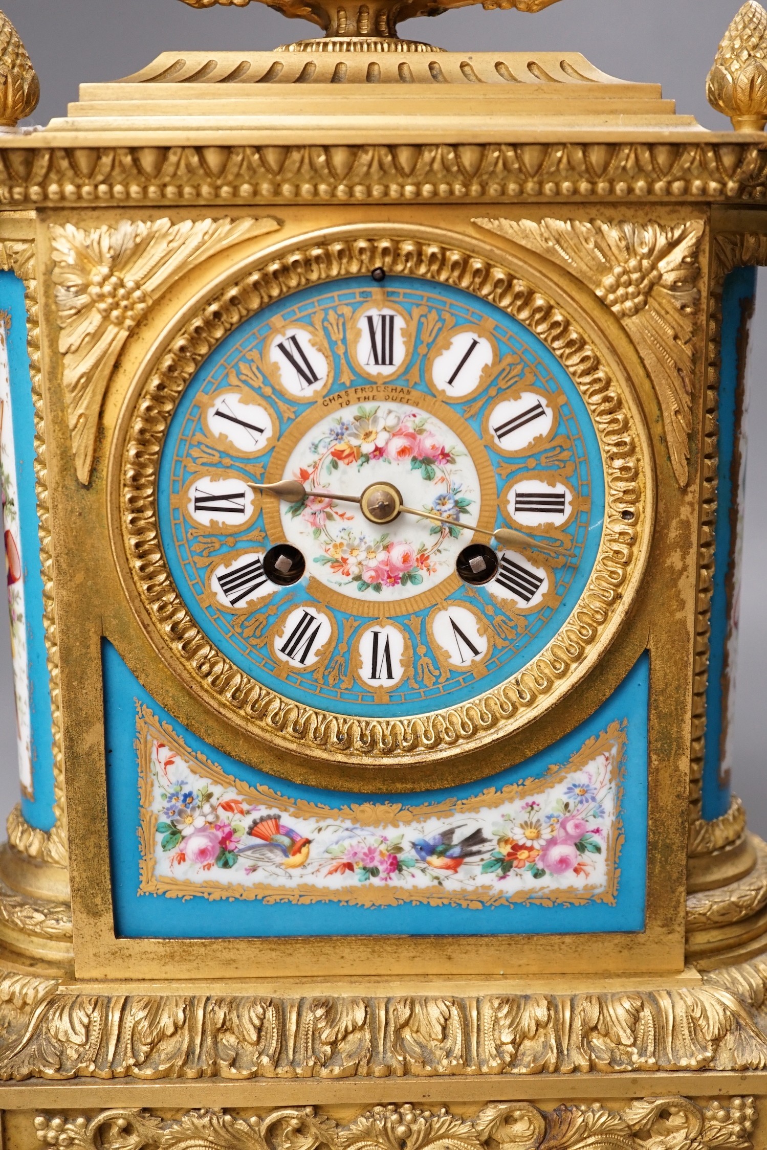 A French ormolu mantel clock, with inset floral decorated porcelain plaques and dial, 34cm high